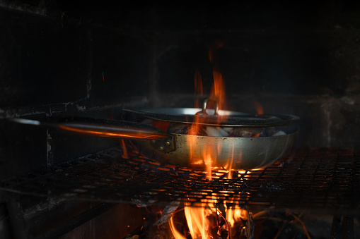 Cooking over the fire in a frying pan