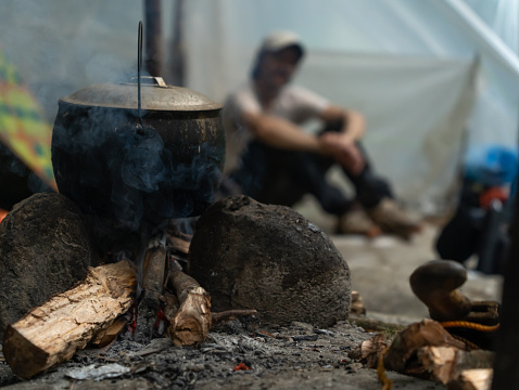 Cooking over the fire in a camp