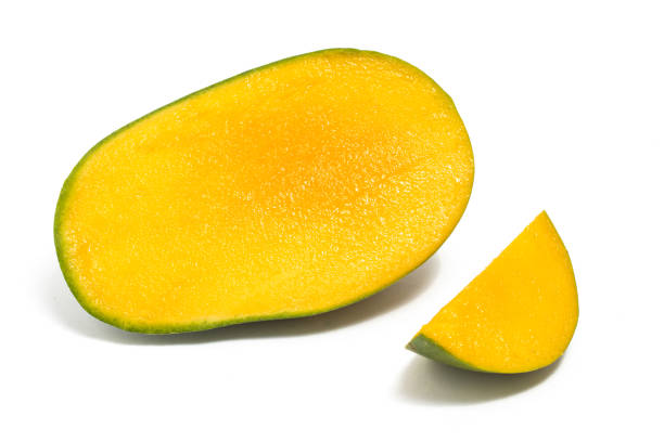 istock Half cut and sliced fresh organic green mango delicious fruit side view isolated on white background clipping path 1938778858