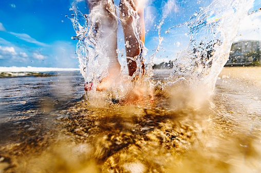 Splashing feet on the beach