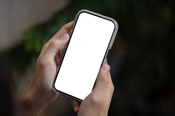 istock Close-up image of a man using his smartphone outdoors. A white-screen smartphone mockup. 1938817318