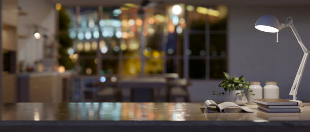 istock Copy space on a study table or working desk in a modern dark living room at night. 1938820003