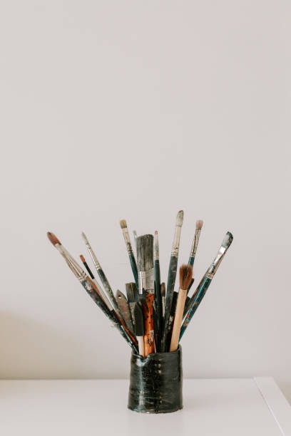istock a collection of used old paint brushes against white background 1938838257