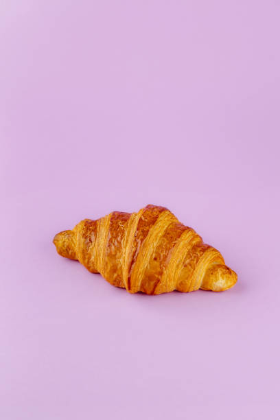istock French croissant on a pink background 1938850366
