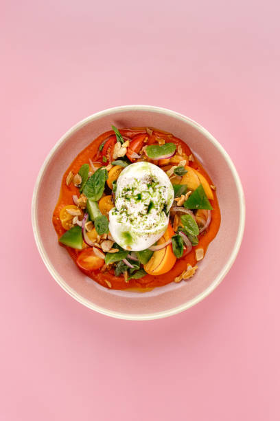 istock buratta in a bowl with fresh vegetables and sauce 1938853555