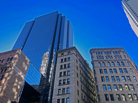 Skyline of downtown Boston.  Brookline Bank building and 53 State Street Building on the corner of State and Congress in Boston, Massachusetts.   On the Freedom Trail.  Blue skies