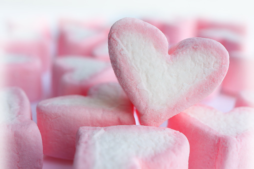 group of pastel pink heart shape marshmallow on white background. Sweet candy for love