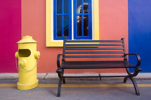 colorful bench and trash bin in the park