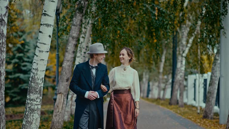 married couple in vintage clothing strolling in park, culture of 19th century, portrait, 4K, Prores