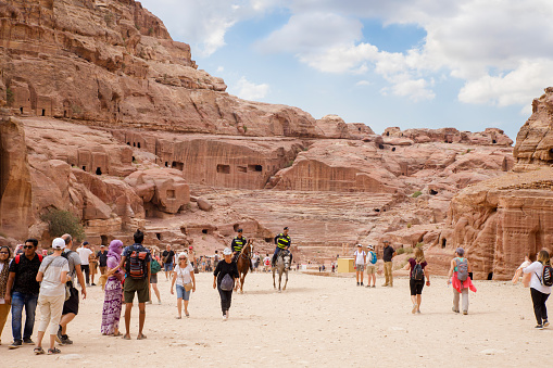 Wadi Musa, Jordan, October 05, 2023 : Numerous tourists explore the tourist route in the Nabatean Kingdom of Petra in the Wadi Musa city in Jordan
