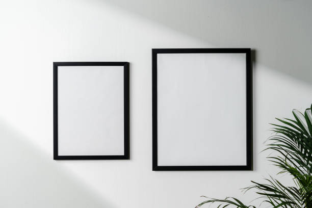 istock Black frames and houseplant against white wall copy space 1939062935