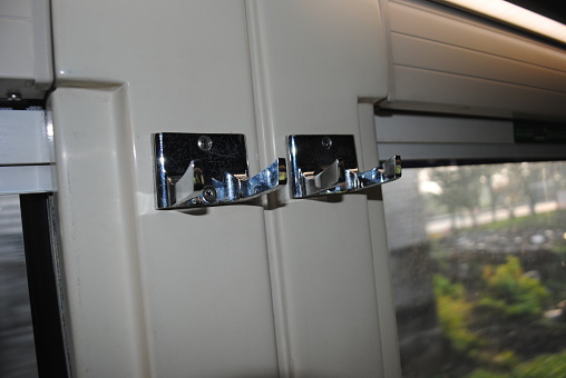Item hanger is placed next to the window inside the Indonesian train.