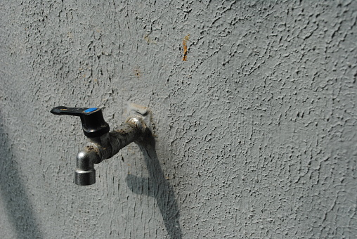 water tap, faucet with stone wall background