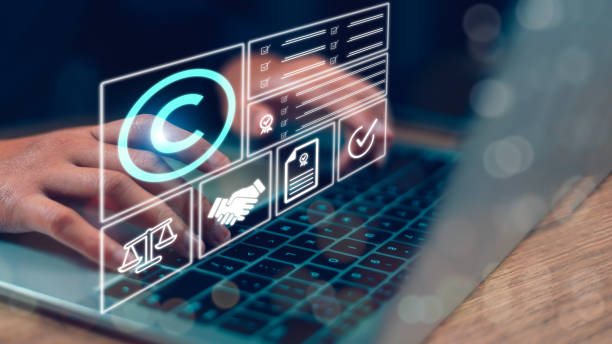 istock Copyright or patent concept, Person's hand using a laptop computer on a futuristic virtual interface screen. copyright icon background, Creation ownership against piracy crime 1939087292