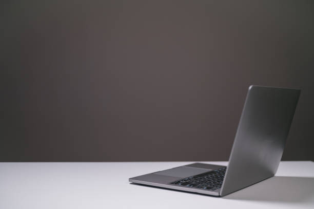 istock laptop computer on desk in office, black background 1939094709