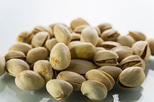 Group of pistachio nuts on white background