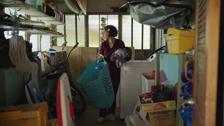 Nurse doing laundry at home after work