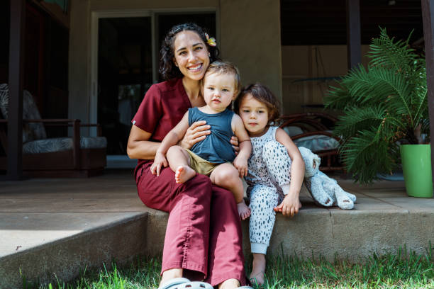istock Working mom and her kids sitting outside their home 1939138248