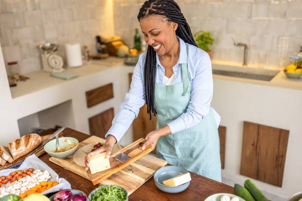 istock Woman rubs cheese on grater in the kitchen 1939154174