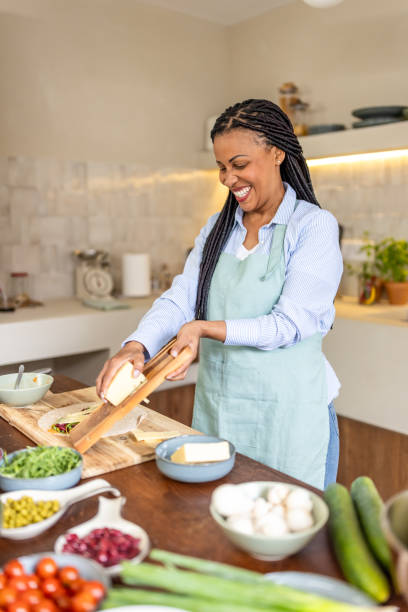istock Woman rubs cheese on grater in the kitchen 1939158404