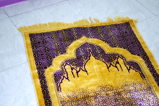 A prayer mat on the floor, illustration of Muslim prayer room for Ramadan theme