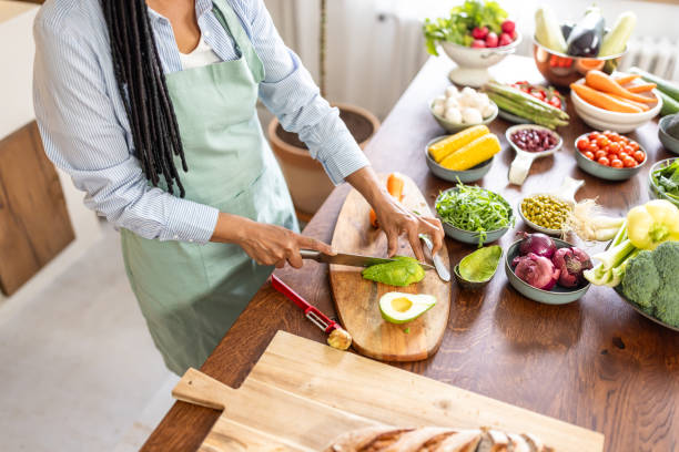 istock Woman cutting avocado for salad 1939173590
