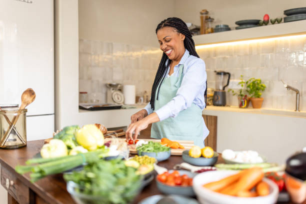 istock Woman making healthy vegetable salad meal 1939184459