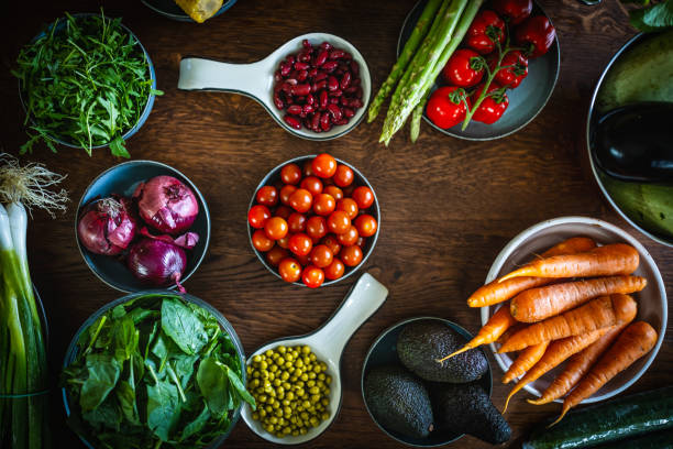 High angle of fresh organic vegetables on a wooden table.
