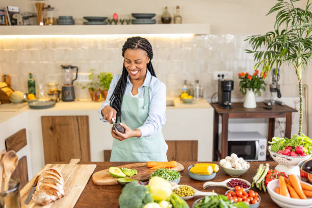 istock Woman cutting avocado for salad 1939189750