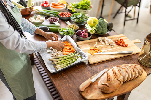 Happy Afro-American woman making healthy meal at home