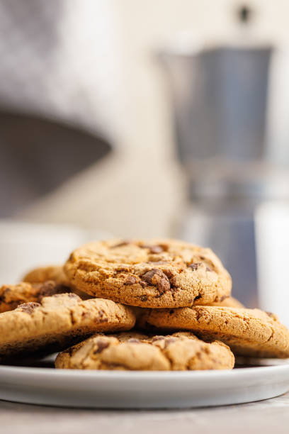 istock Sweet chocolate cookies on plate on kitchen table. 1939197166