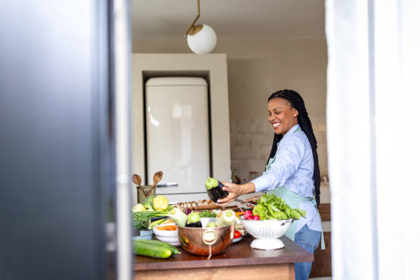 istock Woman making healthy meal in the kitchen 1939197173