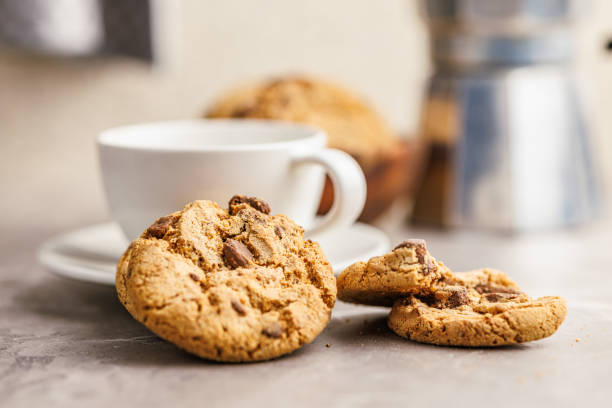 istock Sweet chocolate cookies and coffee cup on kitchen table. 1939197174