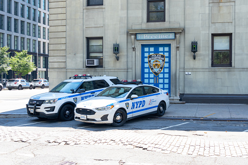 New York City, NY, USA - August 20, 2022: Two Police cars at a Police Station in New York City, USA.