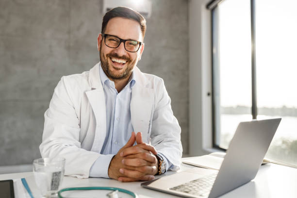 istock Happy medical expert aiming at camera while working at his office. 1939259507