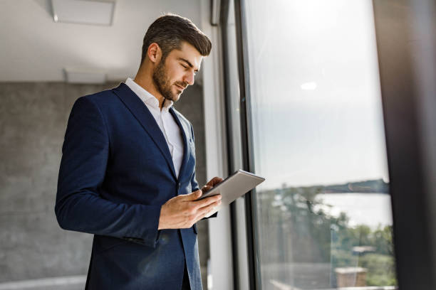 istock Male entrepreneur working on touchpad by the window. 1939261089
