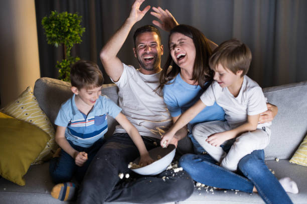 istock Cheerful family having fun on sofa at home. 1939264700