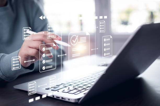 istock Online survey filling out and digital form checklist by laptop computer, Document Management Checking System, online documentation database and process manage files. 1939278789