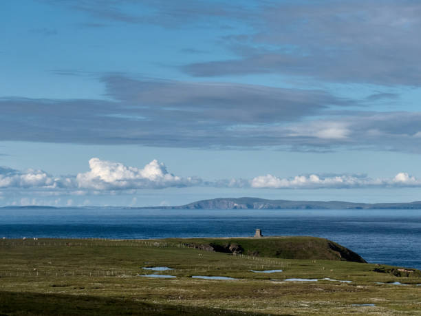 View over Foula and the monument towards Mainland Shetland. \n\nFoula is located in the Shetland archipelago of Scotland and one of the United Kingdom's most remote permanently inhabited islands.  Foula lies 28 kilometres west of Walls in Shetland. 38 people live on the island.