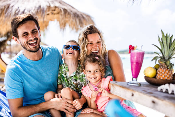 istock Happy parents having fun with their kids on the beach. 1939280941