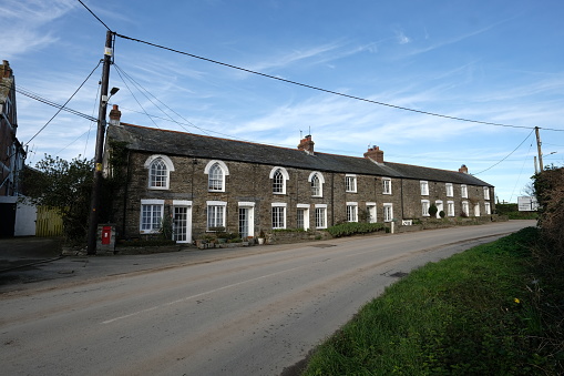 View along the main street in a Cheshire village, UK.  Quaint cottages can be seen.  There are no people in the photograph