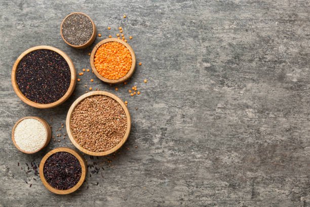 various superfoods in smal bowl on colored background. superfood as rice, chia, quinoa, lentils, nuts, sesame seeds, almonds. top view copy space - quinoa sesame chia flax seed imagens e fotografias de stock