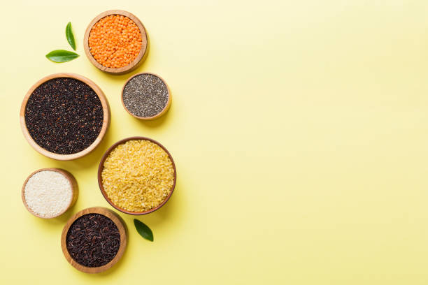 various superfoods in smal bowl on colored background. superfood as rice, chia, quinoa, lentils, nuts, sesame seeds, almonds. top view copy space - quinoa sesame chia flax seed imagens e fotografias de stock