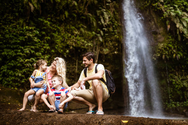 istock Young happy family talking while enjoying in day at rainforest. 1939289503