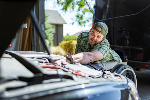 istock Man with disability working on his car at home 1939317644
