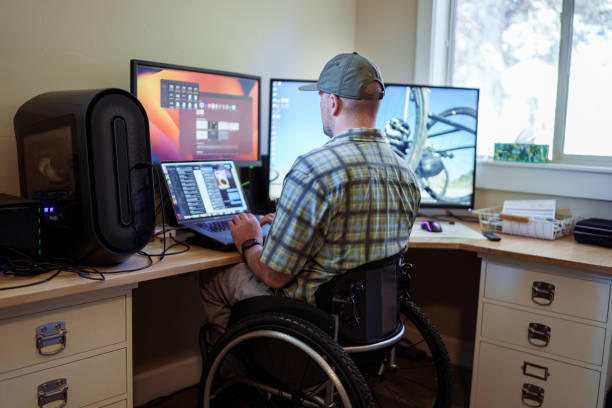 istock Man with disability working in home office 1939318167