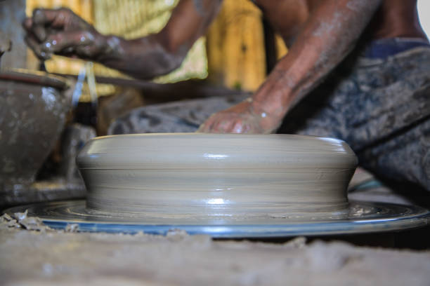 Potter's hands mold clay on a potter's wheel for planting plants. Environmentally friendly products made by human hands,Stay home and work from home