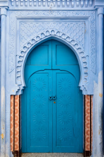 Morocco Fez city. man in traditionalclothig walking pass Fez royal palace gate