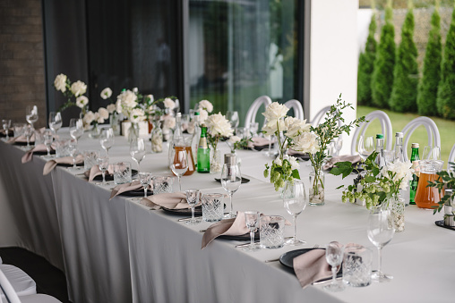 A beautifully decorated table for a wedding event outdoors