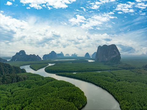 View from above, stunning aerial view of Ao Phang Nga (Phang Nga Bay) National Park featuring a multitude of limestone formations rising majestically from the sea near the coast. Thailand.